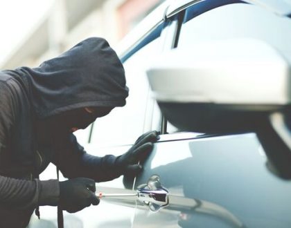 A thief attempting to steal a commercial vehicle, highlighting the importance of fleet theft prevention and vehicle tracking systems.