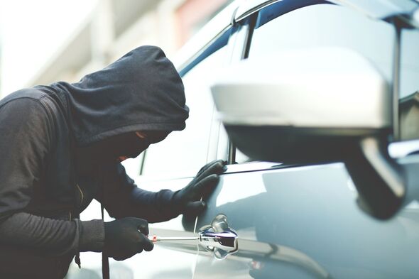 A thief attempting to steal a commercial vehicle, highlighting the importance of fleet theft prevention and vehicle tracking systems.